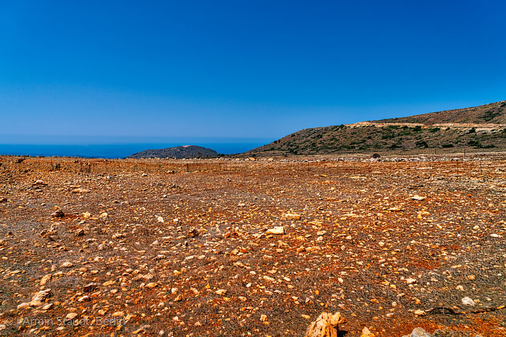 mediterranean landscape with red sand and stones